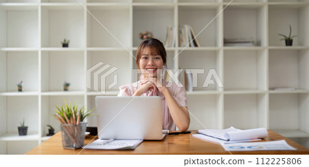 Successful businesswoman inside office at workplace, worker smile and looking at camera with laptop businesswoman is satisfied with results of achievement at work 112225806