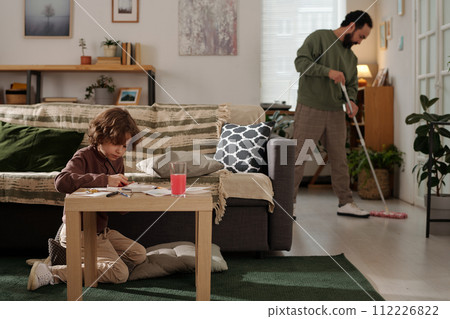 Adorable boy drawing with crayons 112226822