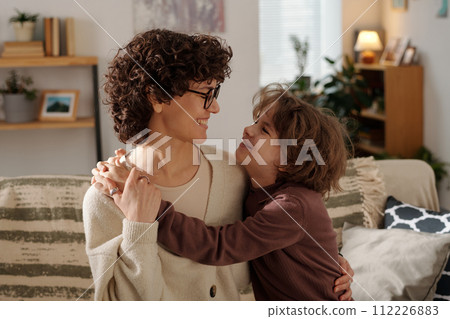 Mother and son embracing each other Mother and son embracing each other 112226883
