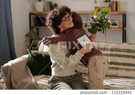 Affectionate boy embracing his mother 112226942