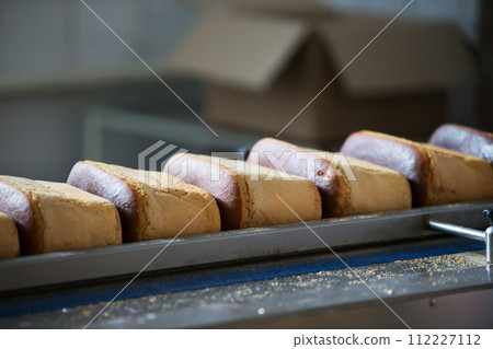 A production line for the production of bread. Bread on a conveyor belt 112227112