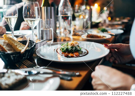 waiter serving salad to couple waiter serving salad to couple 112227488