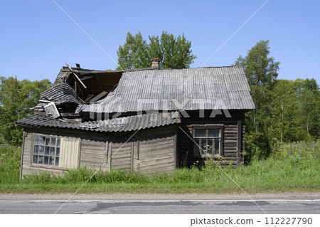 Abandoned dilapidated wooden village house by the road in Karelia Abandoned dilapidated wooden village house by the road in Karelia 112227790