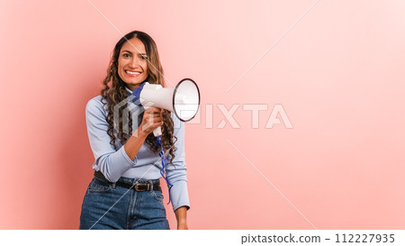 Colombian woman using a loudspeaker and yelling positive Colombian woman using a loudspeaker and yelling positive 112227935