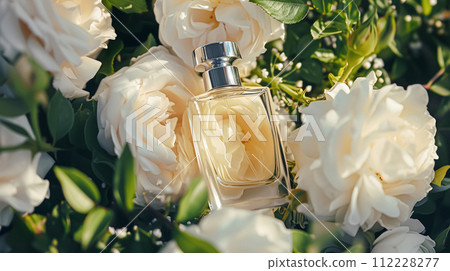 Perfume bottle in flowers, fragrance on blooming background, floral scent and cosmetic product Perfume bottle in flowers, fragrance on blooming background, floral scent and cosmetic product 112228277