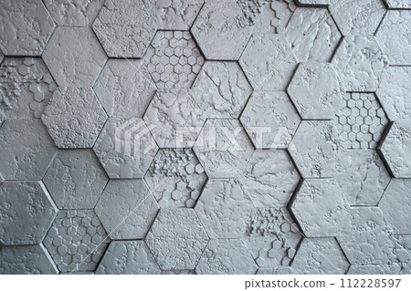 Background made of grey hexagonal gypsum tiles, textured, mosaic. 112228597