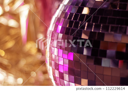 Shiny disco ball in pink tones closeup Shiny disco ball in pink tones closeup 112229614