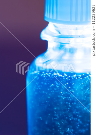 Blue serum in a glass jar close-up Blue serum in a glass jar close-up 112229625