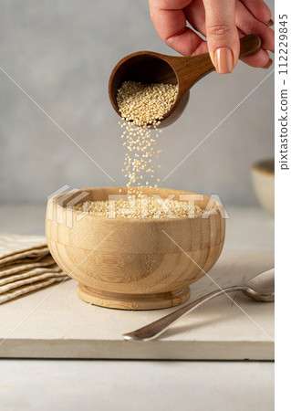 Dry quinoa uncooked in a bowl. Healthy eating Dry quinoa uncooked in a bowl. Healthy eating 112229845