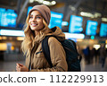 AI-generated content. Travel, happy young woman with backpack, at airport or train station.  112229913