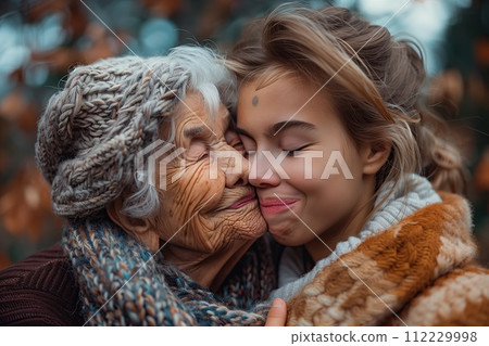 Portrait of grandmother and daughter in sweaters and scarves. Mother's day 112229998