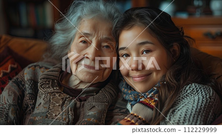 Portrait of a cute little girl and her grandmother at home. 112229999