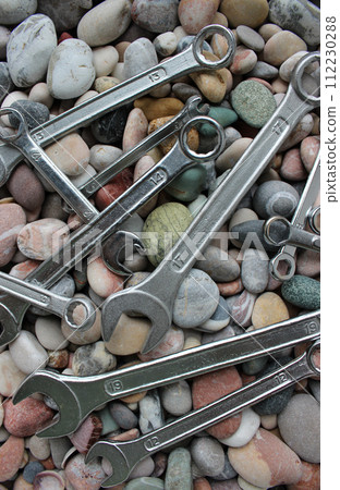 Photo For Vertical Backgrounds Of Wrenches And Spanners Lying On A Smooth Stones  112230288