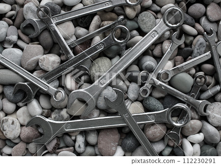 Different Iron Wrenches On A Sea Stones Black And White Stock Photo For Backgrounds Different Iron Wrenches On A Sea Stones Black And White Stock Photo For Backgrounds 112230291