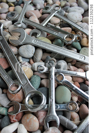Variety Spanners Scattered Across Sea Pebbles Vertical Photo  112230298