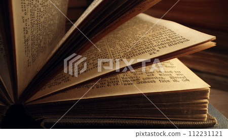 Opened saved medieval book with ancient writings. Religious literature, archival Opened saved medieval book with ancient writings. Religious literature, archival 112231121