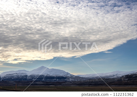 Landscape with mountains and a cloud, North Iceland 112231362