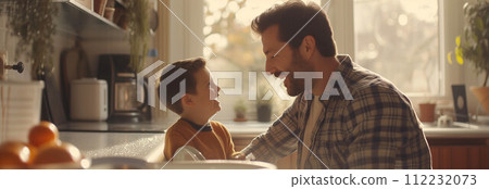 Caucasian father and son washing dishes in the kitchen. Caucasian father and son washing dishes in the kitchen. 112232073