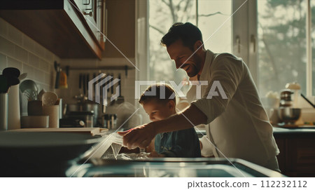 Caucasian father and son washing dishes in the kitchen. 112232112