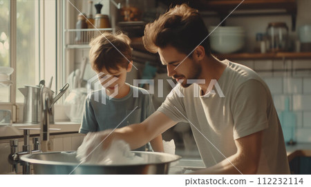 Caucasian father and son washing dishes in the kitchen. 112232114