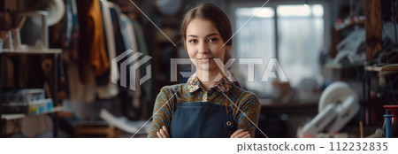 Caucasian woman smiling with confidence in tailor shop. 112232835