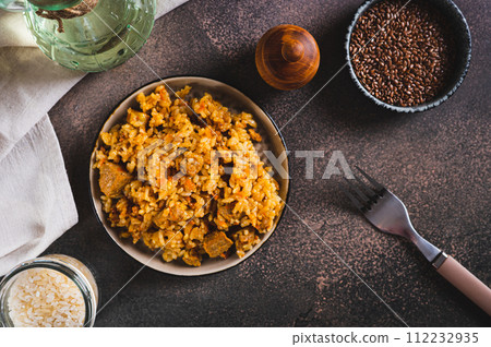 Delicious Asian pilaf with meat on a plate on the table top view 112232935