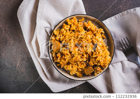 Close up of delicious Asian pilaf with meat on a plate on the table top view 112232936