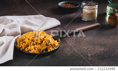 Delicious Asian pilaf with meat on a plate on the table web banner 112232946