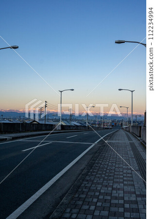 Mountains bathed in the morning glow seen from the overpass Mountains bathed in the morning glow seen from the overpass 112234994