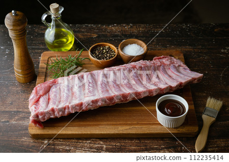 raw pork spare ribs on wooden board raw pork spare ribs on wooden board 112235414