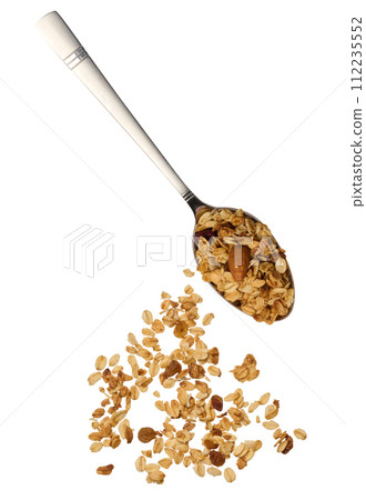 Oatmeal, raisins and almonds. Granola in metal spoon 112235552