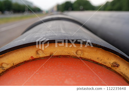 Steel pipe with heat insulation on construction site close up 112235648