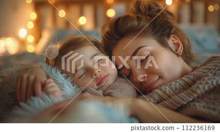 Woman and Little Girl Sleeping on Bed 112236169