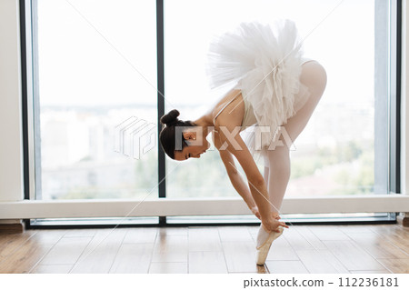 Classical Caucasian Ballet dancer side view. 112236181