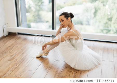 Side view portrait of talented ballerina finished her wonderful performance. Side view portrait of talented ballerina finished her wonderful performance. 112236244