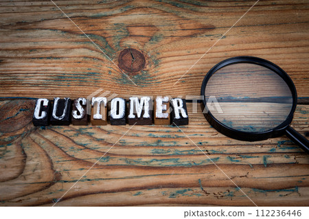 CUSTOMER. Alphabet letters on wood texture background CUSTOMER. Alphabet letters on wood texture background 112236446