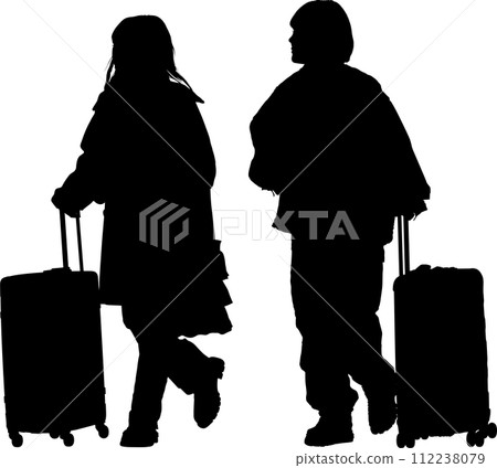 Silhouette of two female travelers walking with a carry case 112238079