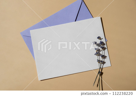 Empty white envelope paper card note template mock up. Copy space for your text. Lavender flower. Greeting or invitation card blank with envelope. Top view 112238220