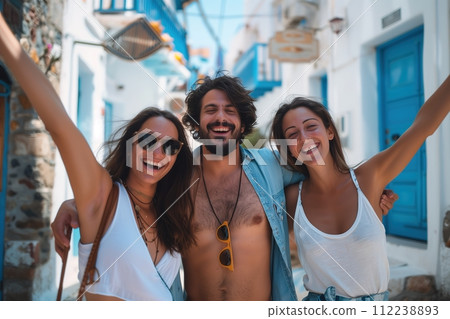 Three people are smiling and posing for a picture on a street 112238893