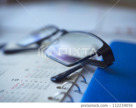 Calendar, notebook and glasses placed on the table Calendar, notebook and glasses placed on the table 112239056