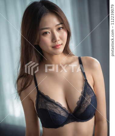 a beautiful asian woman wearing a black bra 112239079