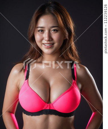 an asian woman in pink lingerie posing for the camera 112239126