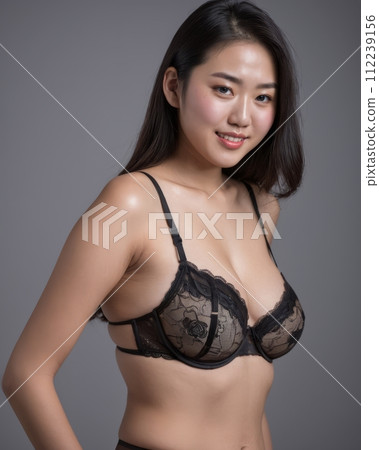 an asian woman wearing a black bra and panties 112239156