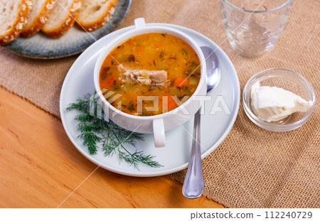 Traditional Russian soup rassolnik made from pickled cucumbers, pearl barley, and beef kidneys 112240729