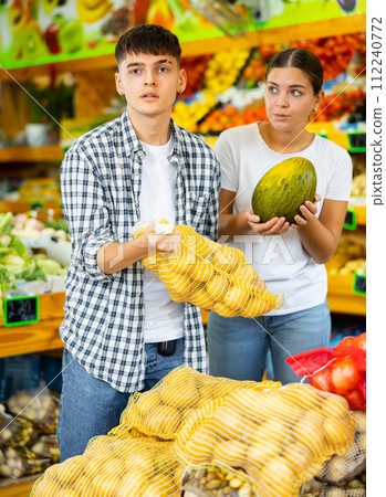 Happy young couple chooses products 112240772