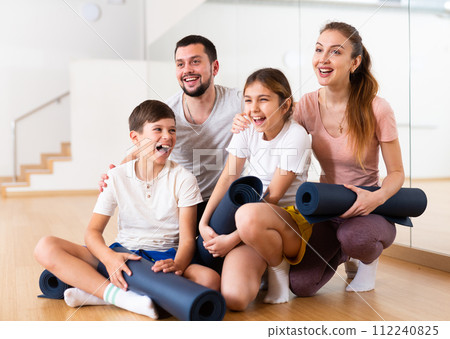 Portrait of happy family at yoga studio 112240825