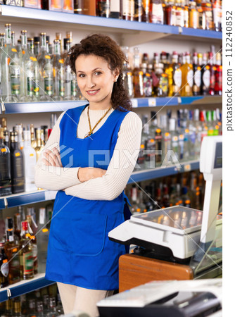 Woman works as salesperson in alcohol department of Russian store. Woman works as salesperson in alcohol department of Russian store. 112240852