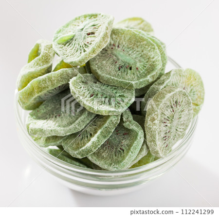 Dried tropic fruit kiwi in glass bowl on white surface 112241299