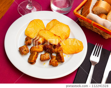 Grilled pork loin chops with baked potato 112241328