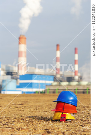 Worker Hard hat red Walkie talkie at Power stations manufacturing electrical industrial plant. Construction hard hat safety helmet at Electric power building refinery engineering safety tools Worker Hard hat red Walkie talkie at Power stations manufacturing electrical industrial plant. Construction hard hat safety helmet at Electric power building refinery engineering safety tools 112241830